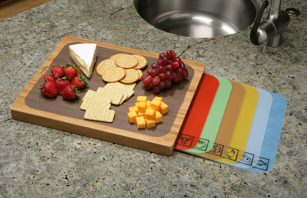 A cutting board with built-in storage space for a variety of mats.