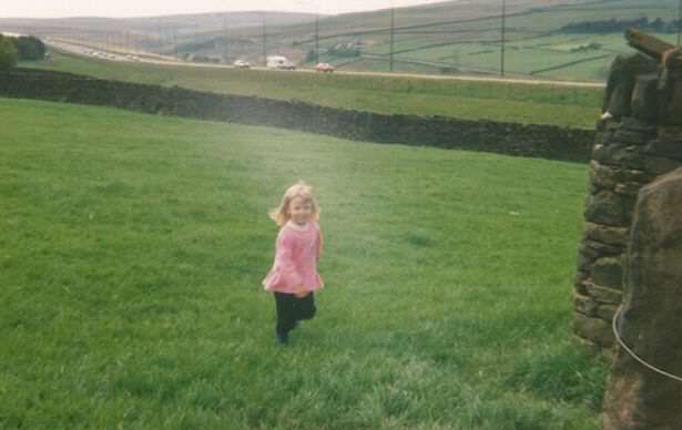 Kimberley as a child with the motorway behind her