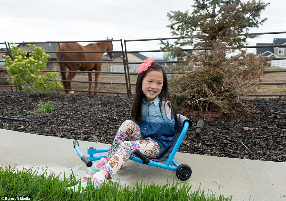 Sophi has a specially modified tricycle which she is able to steer with her feet to enable her to get around more quickly 