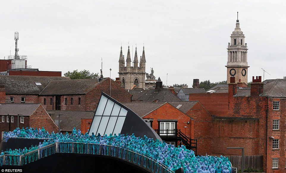 Around 3,200 people took part in a huge art installation in Hull, pictured, stripping off their clothes and painting themselves blue