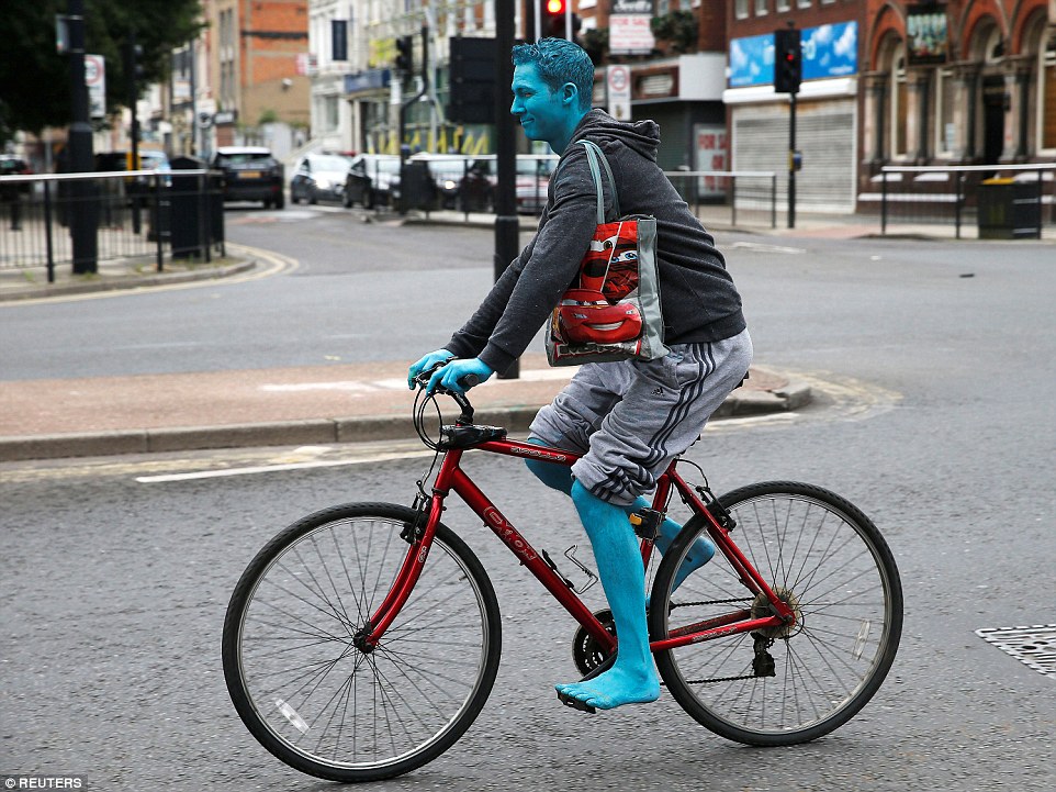 The paint left people looking more like Smurfs as they made their way home, including this cyclist, pictured