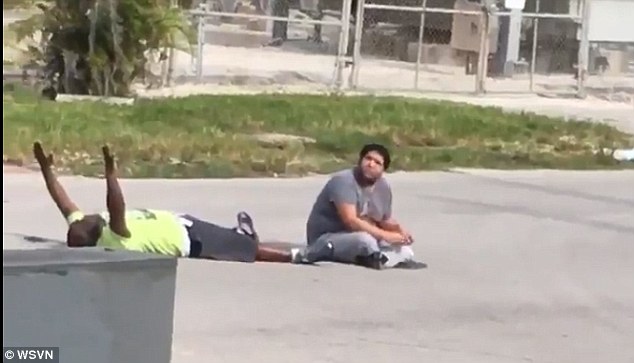 Therapist Charles Kinsey, 46, (left) was shot in North Miami while he was on the ground with his hands up. Throughout the ordeal, he tries to soothe his autistic patient (right), who was playing with a toy truck