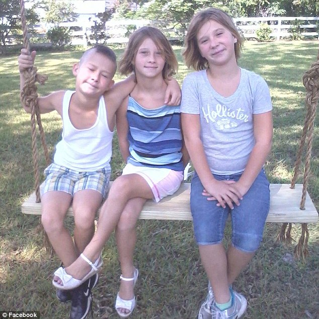 Katelyn, her twin Savannah, and younger brother Dylan sit in their family's backyard, years before the tragedy that claimed the lives of two of them
