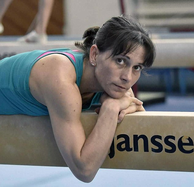 The 41-year-old rests on the beam during a break in training. She has revealed that she was asked to represent Russia but refused as she wants to compete for her home country 