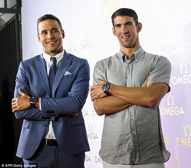 Back to the grin: Phelps was pictured with South African rival Chad le Clos (left) at an Omega promotional event in Rio on Monday night