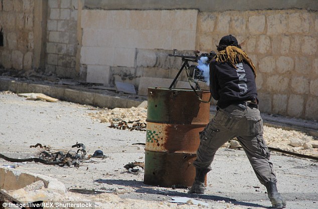 A fighter in Aleppo fires a heavy machine gun that's resting on a metal battle