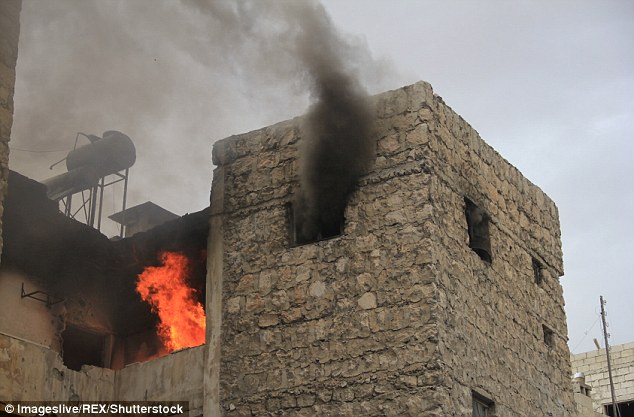 A building burns in Aleppo following fierce fighting between the Syrian regime and rebel factions