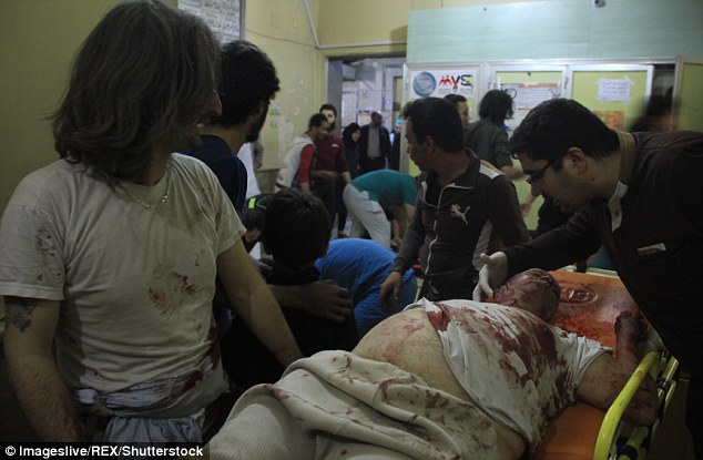 A civilian receives treatment after a rocket attack in the As Sukkari area of Aleppo