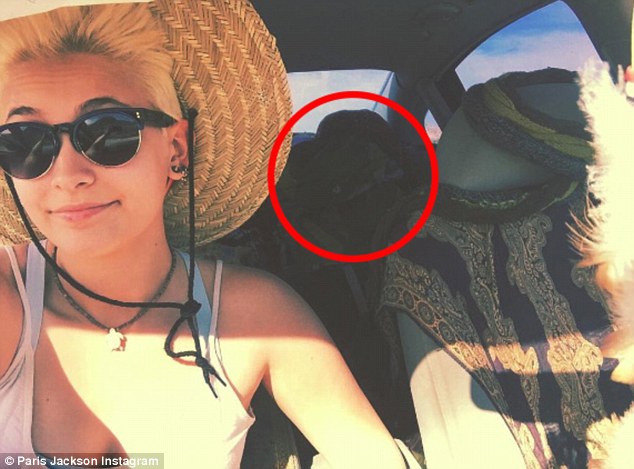 You Are Not Alone... Commenting on a spooky car selfie posted by his daughter Paris Jackson, 18, fans are now claiming that the shadowy form obehind her is actually the singer