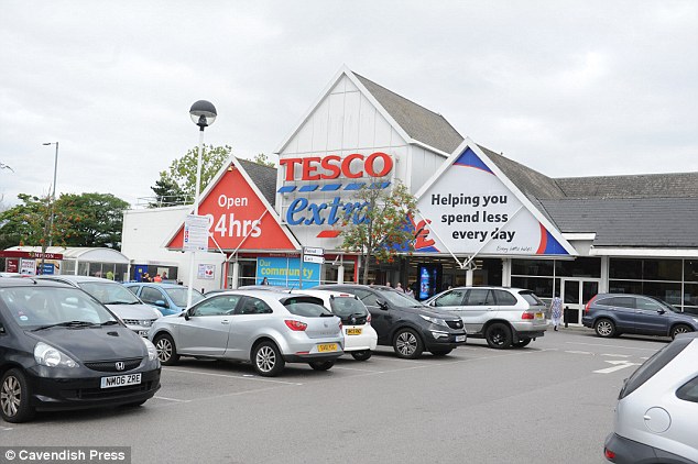 Police have arrested a man after a newborn baby was punched in the face at random in the middle of a Tesco supermarket (pictured)