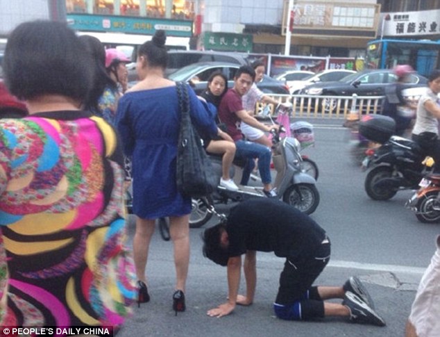 Bizarre sighting: The man was seen crawling on his hands and knees along the busy road
