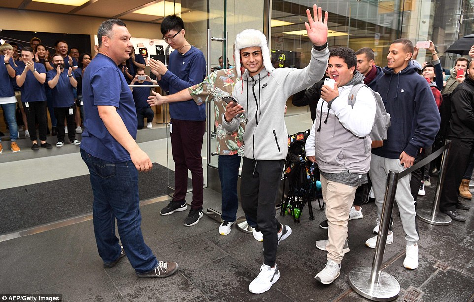 Sydney: The first punters in the queue enter Apple's flagship store in Sydney, Australia on Friday morning