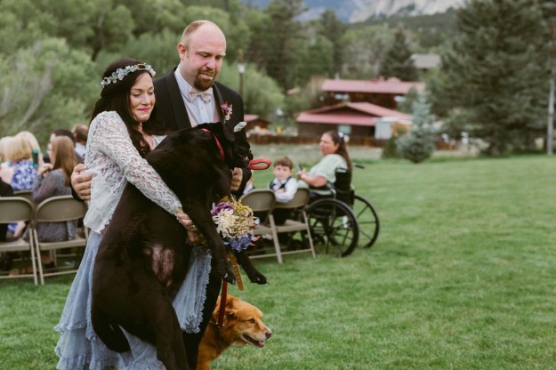 Charlie was too tired to walk back, so Katie Lloyd, the maid of honor and O'Connell's sister, scooped up the 80-pound dog and carried him back in her arms.