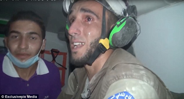 Heartbreaking: After recovering the baby girl, Abu Kifah burst into tears and held her tight to his chest while he got into an ambulance and took her to one of the makeshift hospitals in Idlib