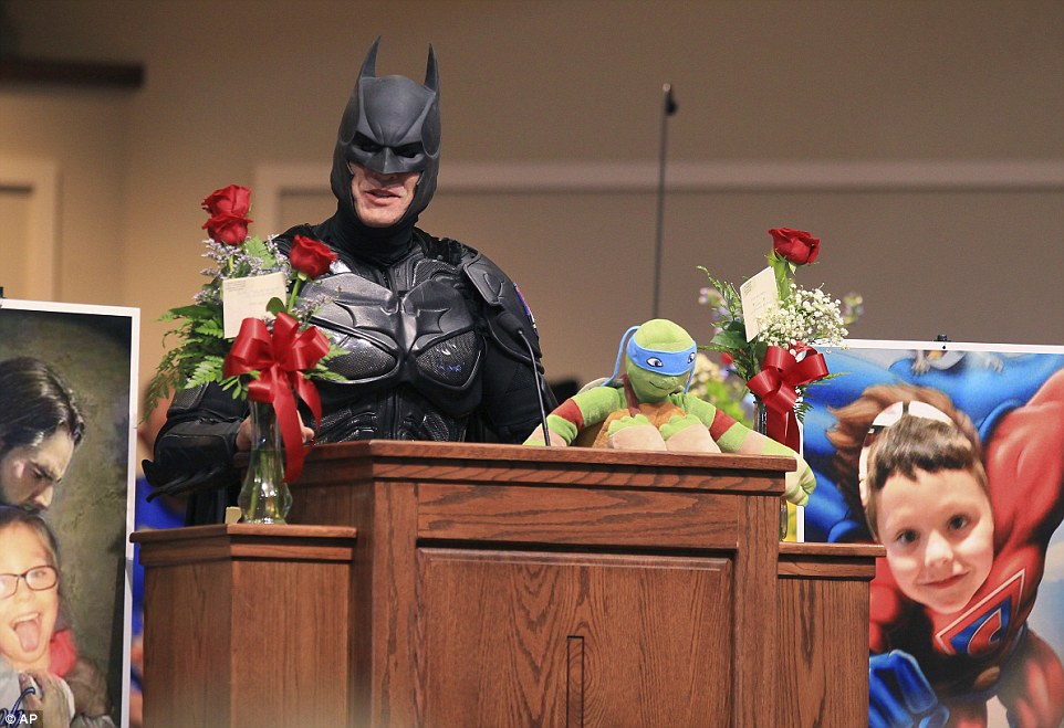 John Buckland, dressed as Batman, speaks during a superhero-themed funeral service for Jacob Hall at Oakdale Baptist Church on Wednesday