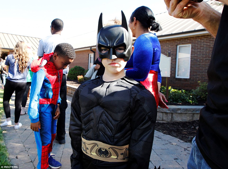 Landen Gilbert, dressed as Batman, stands in line to enter Oakdale Baptist church for the funeral of his cousin Jacob