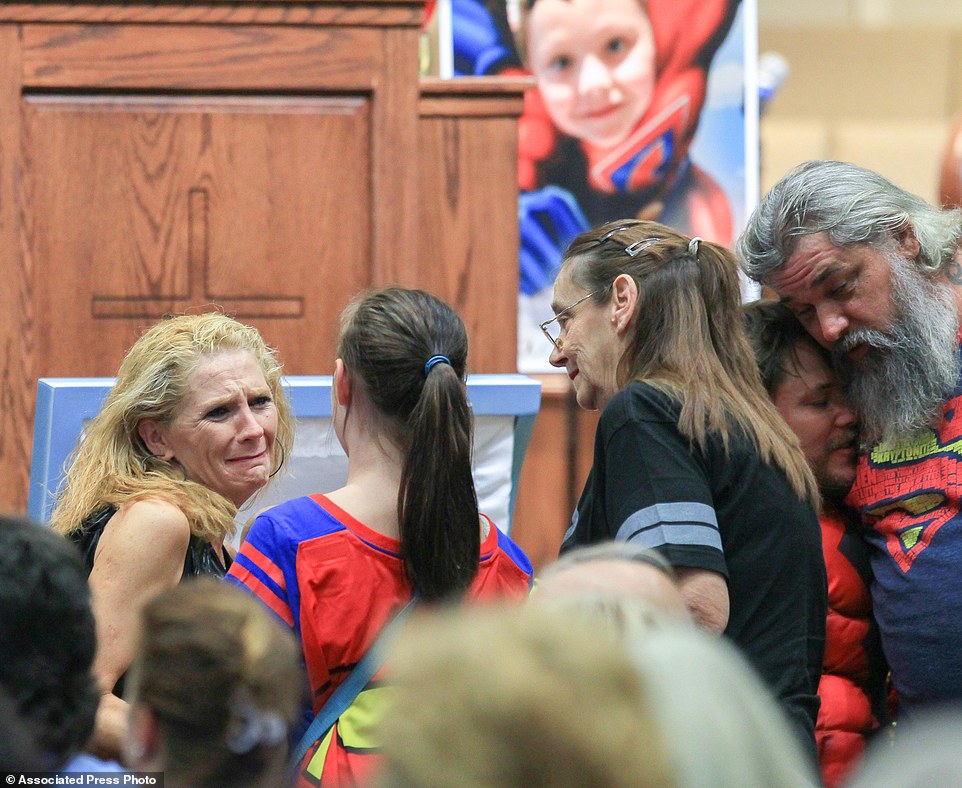 Jacob's mother Renae Hall, left, talks to Starr Henderson, 12, during a wake service at Oakdale Baptist Church on Tuesday