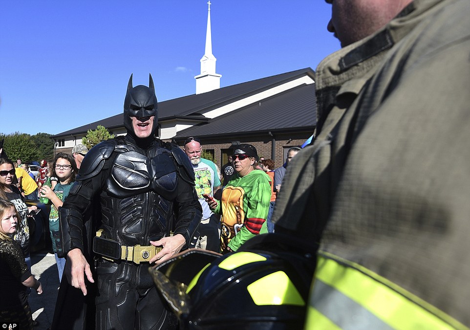 Jacob Hall's family have encouraged people to dress as superheroes to celebrate what he enjoyed. Above, a man dressed as Batman arrived at the funeral