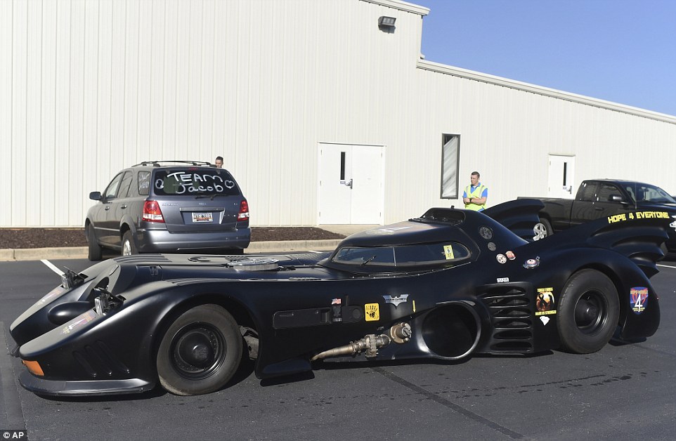 A Batmobile arrives before a superhero-themed funeral service for Jacob Hall, a six-year-old boy who was killed in a school shooting last week