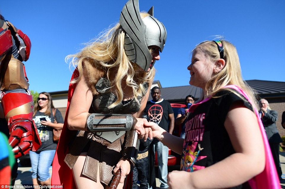 A woman dressed as Thor speaks with a young girl ahead of the funeral service in Townville, South Carolina, on Wednesday