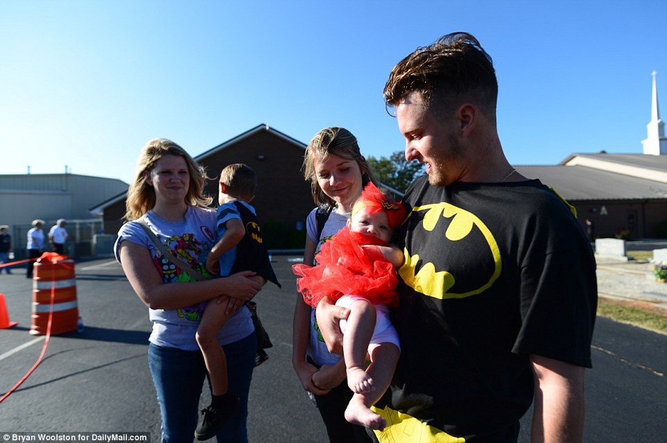 Jacob Hall's family encouraged people to dress as superheroes to celebrate what he enjoyed. Above, people arrive in superhero-themed outfits for the funeral