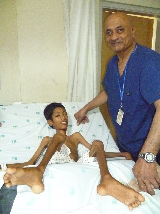 In February Mahendra spent a fortnight in Apollo hospital before being allowed to go home to recover in the hope his neck would not bend again. Pictured: With Dr Rajagopalan Krishnan