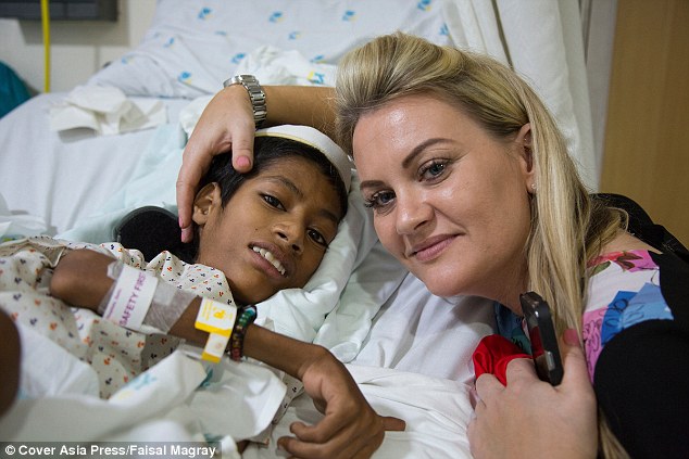 Now, seven months on, his neck is still straight and Mahendra¿s future is looking much brighter. Pictured: The schooboy in hospital with Julie, who raised £12,000 for his operation 