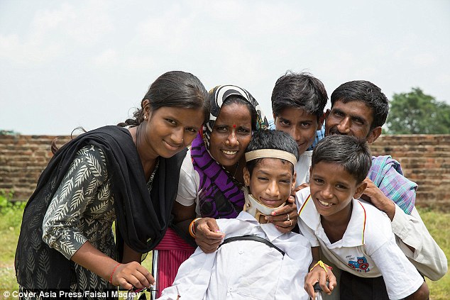Recovery: Mahendra's family are overjoyed that the teenager can finally go to school. His father Mukesh (back far right) told MailOnline: 'I can finally say we are a happy family now. Happiness has found our address after Mahendra¿s surgery. I feel so blessed.'