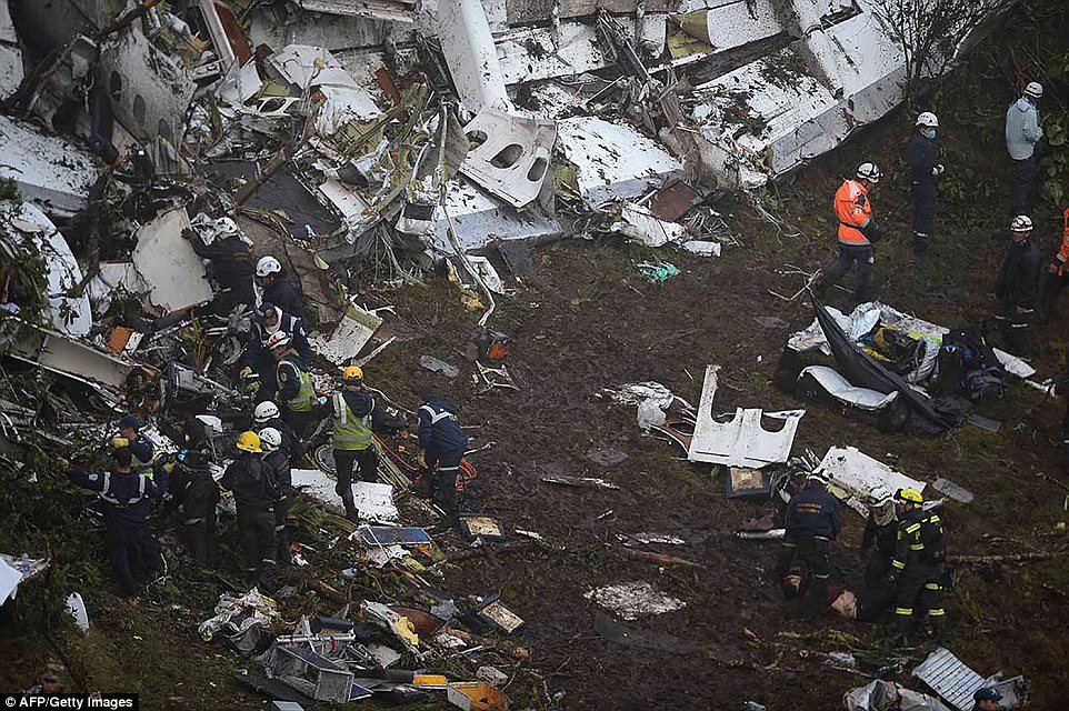 Wreckage from the plane is scattered over a large area as rescue workers search for bodies 