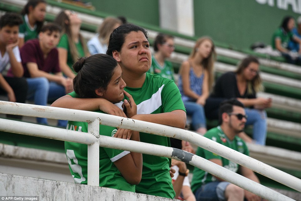 Distraught fans inside Chapecoense's Arena Conda stadium try to come to terms with their loss