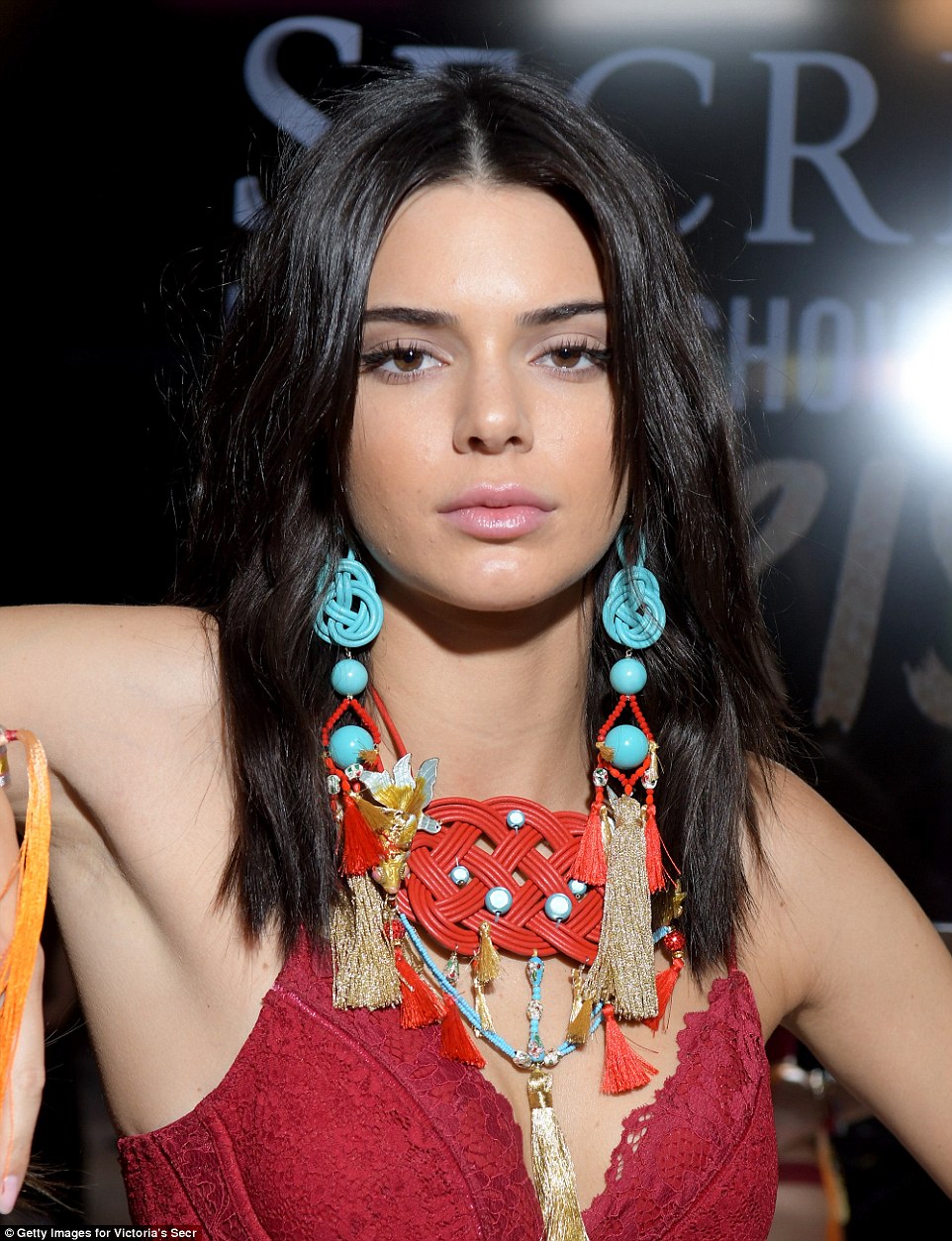 What a jewel! She gave backstage photographers a closer look at her elaborate chandelier earrings and statement necklace
