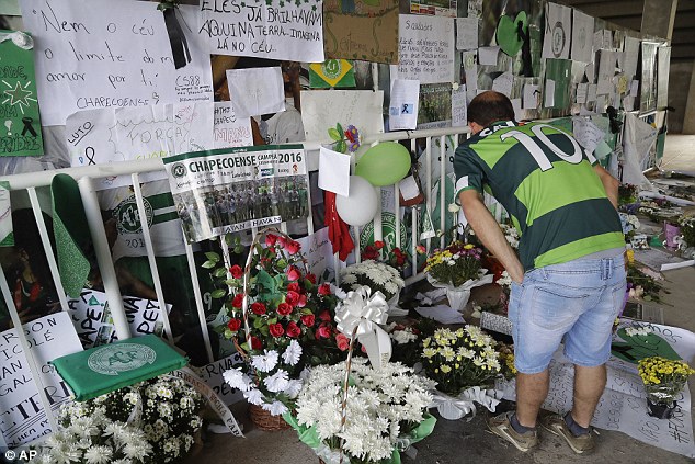 A Chapecoense fan reads messages at the Arena Conda stadium in Chapeco, which has become a makeshift memorial to the 71 people who died on the plane