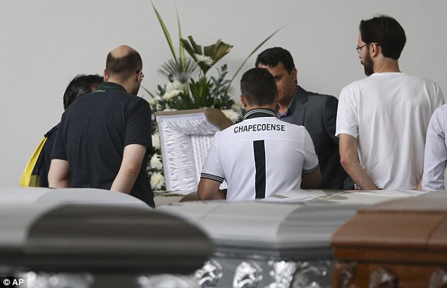 Chapecoense's board of directors stand in car park of a funeral home in Medellin where coffins containing the remains of the victims of the Colombian air tragedy have been placed