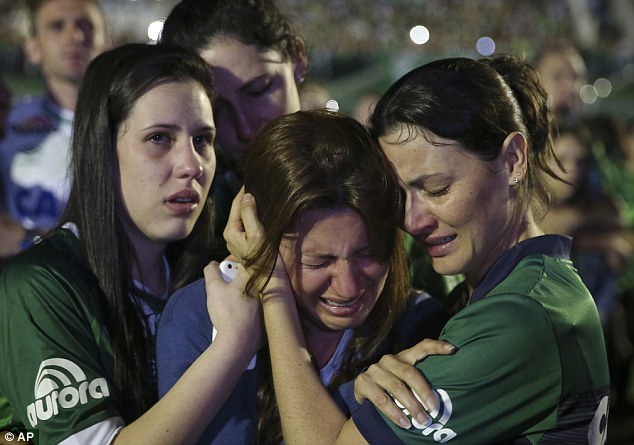 Grieving Chapecoense players huddled together in front of tens of thousands of supporters at the team's stadium in Chapeco, southern Brazil on the night the club was supposed to be competing in the Copa Sudamericana final