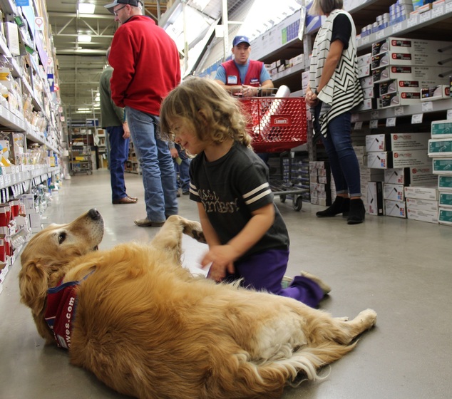 Tinley Farmer, 4, pets Charlotte, as her mother, Jessica, right, talks to Lowe's employee Clay Luthy. The pair are warming hearts across the nation