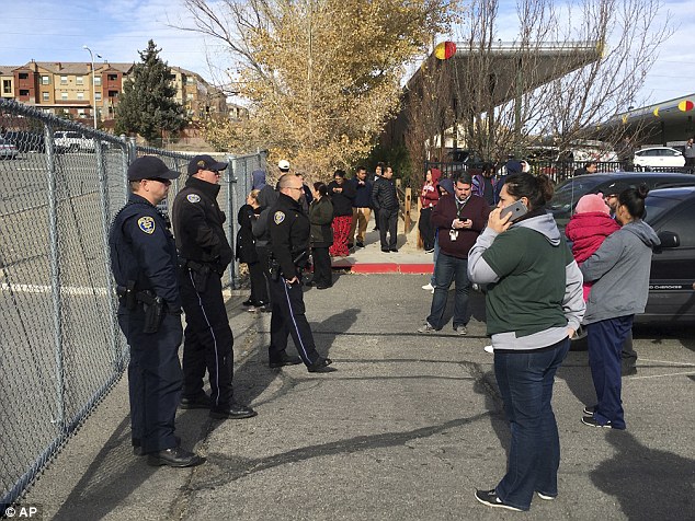 Parents wait outside Hug High School after the officer-involved shooting Wednesday