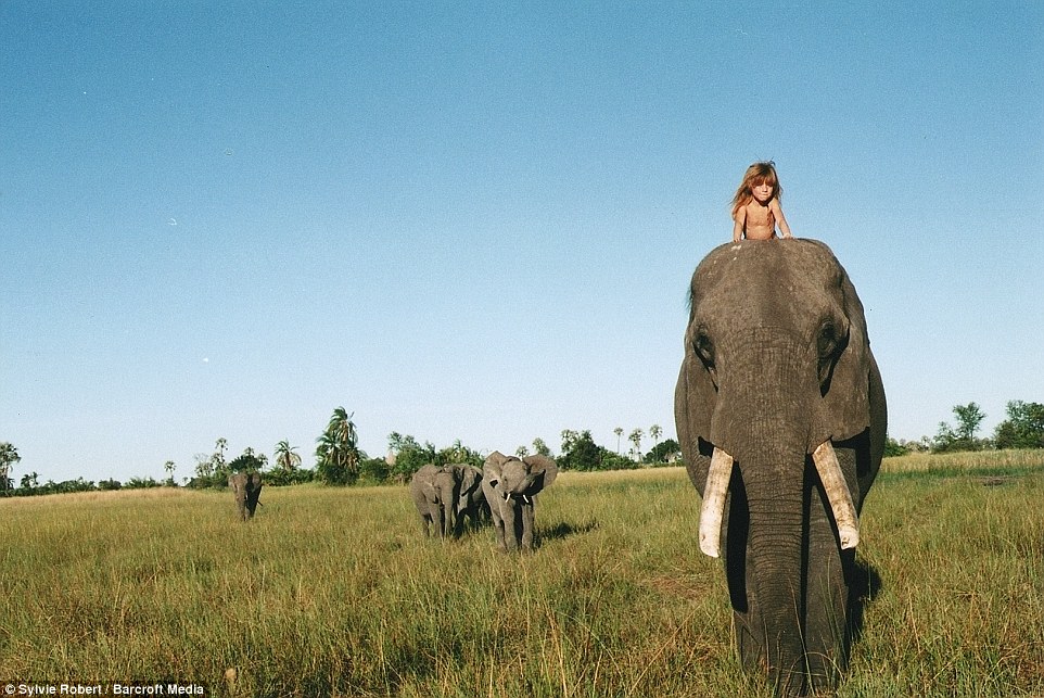 Incredible: Her mother snapped this image of Tippi riding on the top of elephant Abu's head in Botswana when she was six
