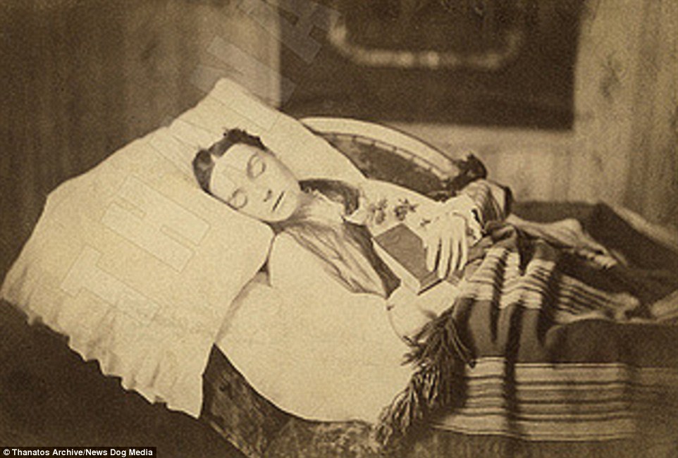 This image, from 1875, apparently shows a dead teenage girl clutching a Bible, as if to protect her in the after-life