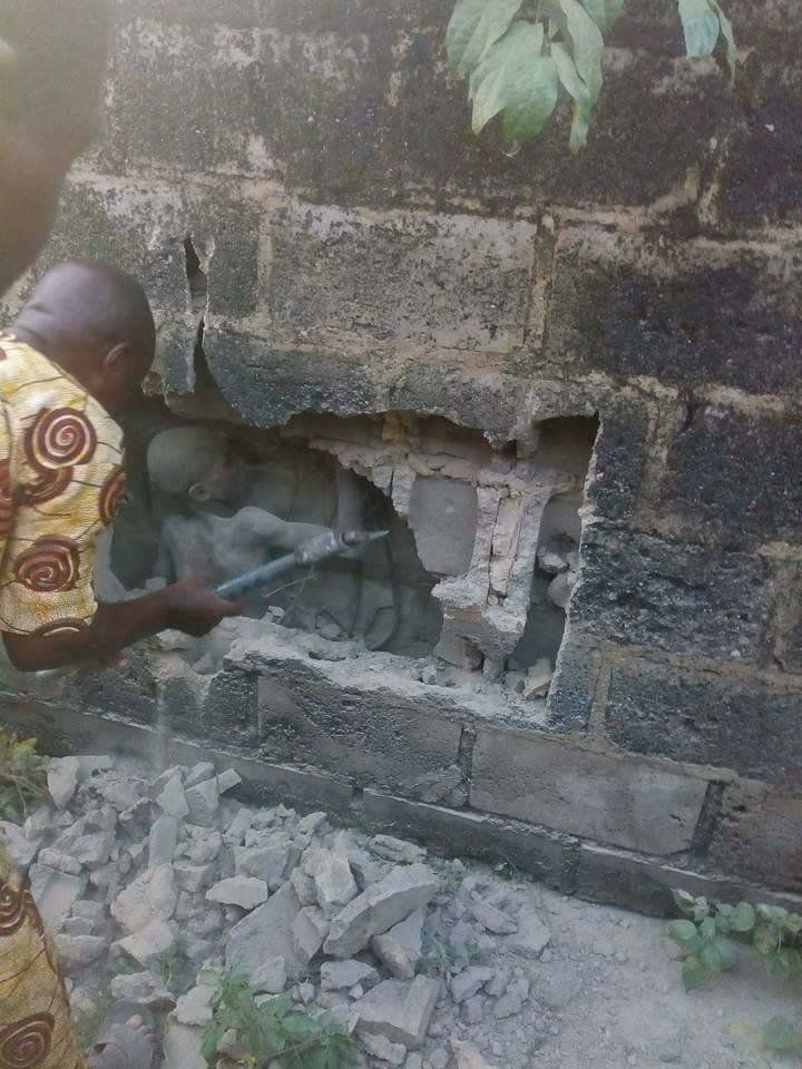 BOY, 12, FOUND ALIVE AFTER THREE DAYS TRAPPED IN WALL This is the incredible moment a 12-year-old boy is rescued after spending THREE DAYS trapped in a tiny gap between and house and a wall. Aduragbemi Saka had been visiting a cafe alone when he started playing in 12-inches wide gap between the breeze block wall and a student house. But he became stuck and with no relatives nearby he spent three days crying to himself - with passersby ignoring the sounds. Eventually neighbours heard the boy singing to himself and they looked inside the gap to see him curled up in a ball. Police smashed through the wall and pulled him out covered in dust but still alive in the Oduduwa Area of Ondo state, Nigeria. Resident Felicia Olaniyi said the by had run away from his grandmother who had been looking after him at the time. She said: ''I asked my neighbours if they were aware of the strange voice inside the wall and they were also confused about what was going on there. ''So we got a ladder to trace where the voice was coming from and found the young boy where he was stuck. A policeman had to break the wall to rescue him.'' Another neighbour Charity Adebayo said: ''We heard a voice speaking that 'I am Judas Iscariot. The following day we asked for a ladder and found him. We discovered the poor boy.'' The youngster has since been reunited with his grandmother. ©Exclusivepix Media