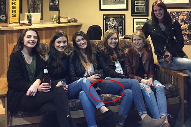 The young woman in the middle of the picture appears to have no legs