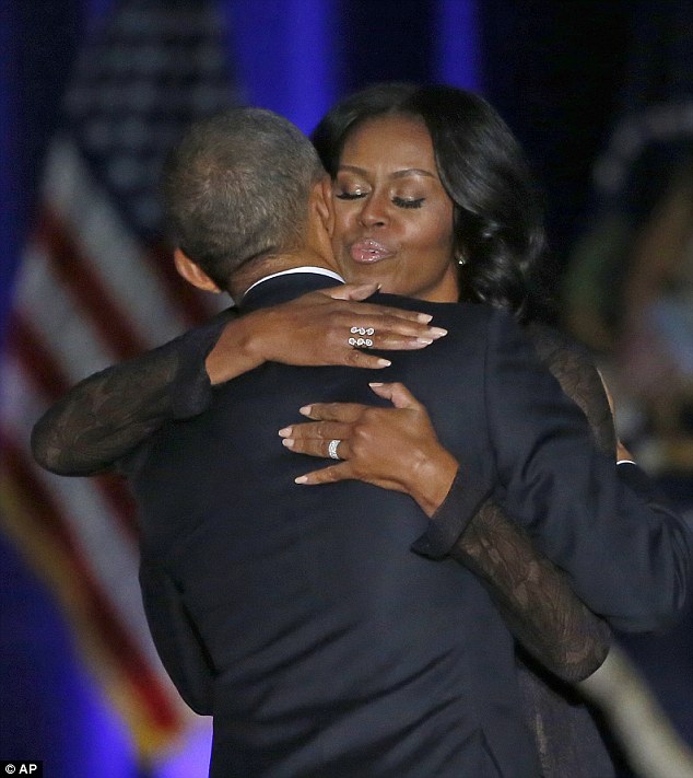 Pictured, the president and first lady sharing a hug on stage at McCormick Place in Chicago