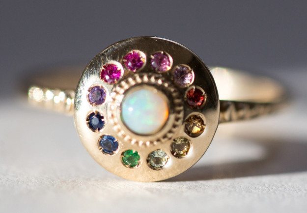 A rainbow UFO-like ring that's made up of too many gemstones to list.