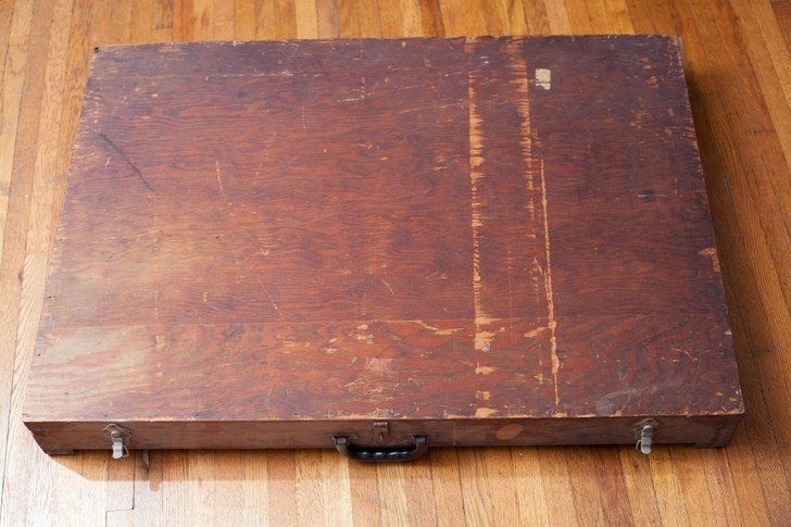 A man found this mysterious box in a dumpster and what he found inside was absolutely baffling. The large wooden box showed signs of some wear and tear, with a simplistic feel displaying only a pair of locks for safety of its contents.