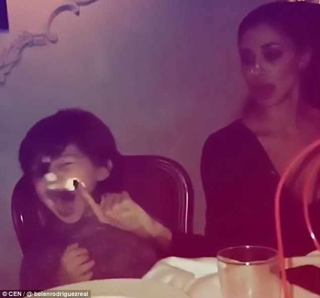 Or tender moment? The model then wipes her finger along the plate and dabs whipped cream on her son's nose and cheek as he giggles happily. The video was shared on Instagram