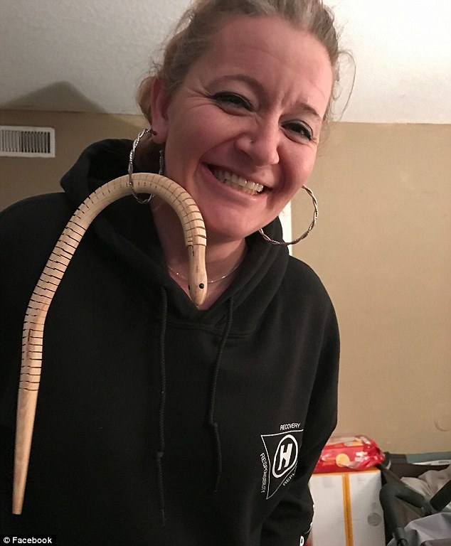 Having a laugh: One of Ashley's friends (pictured) poked fun at her situation with a wooden toy snake looped through a hoop earring