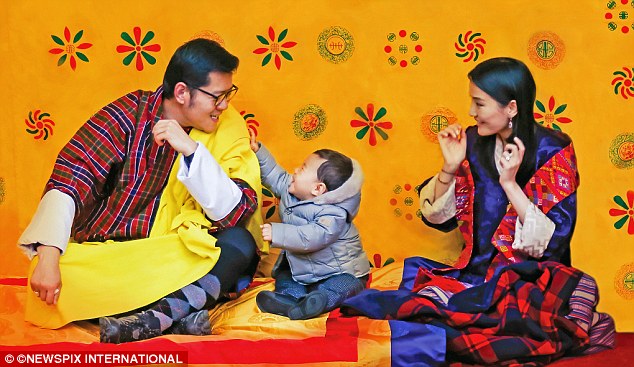 What a family: The photo was taken at Lingkana Palace where he resides with his parents, King Jigme Khesar Namgyel Wangchuck, 36, (left) and Queen Jetsun Pema, 25, (right)