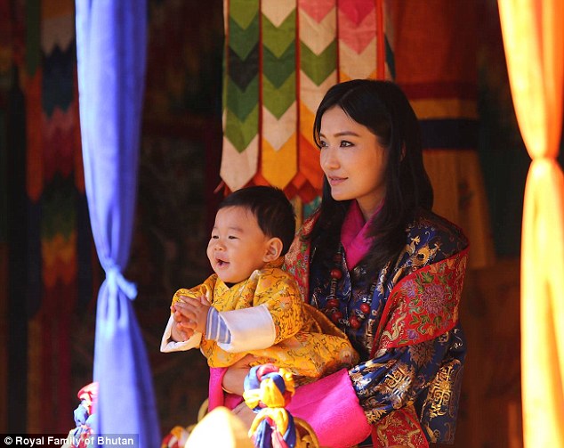 Cuddles with mom: Queen Jetsun Pema dotes on the little Prince as they celebrated Bhutan's National Day back in December