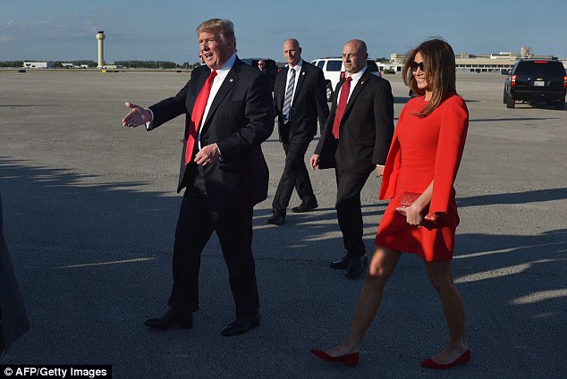 The first lady, who wore a $2000 Givenchy red cape dress, was all smiles as her husband moved away to shake hands with well-wishers