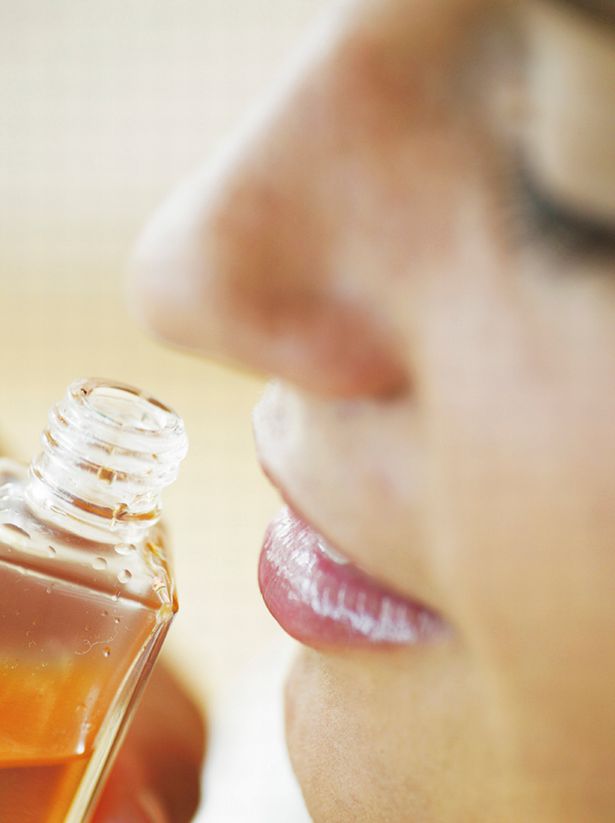 Smelling bottle of perfumed body oil