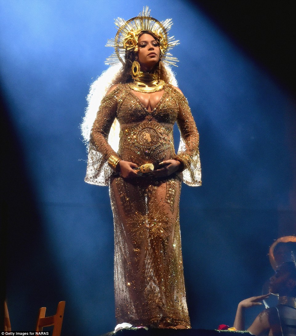 Twinning: Beyonce cradled her bump while onstage while standing on a pedestal
